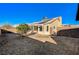 Backyard with gravel landscaping, stone patio, and covered patio area at 2177 Bridle Wreath Ln, Las Vegas, NV 89156