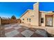 Backyard featuring a tan home and a red-and-grey tiled patio at 2177 Bridle Wreath Ln, Las Vegas, NV 89156