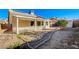 Backyard featuring gravel landscaping, stepping stones, and a covered patio at 2177 Bridle Wreath Ln, Las Vegas, NV 89156