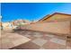 Backyard featuring a brick wall, red-and-grey tiled patio, and a view of the mountains at 2177 Bridle Wreath Ln, Las Vegas, NV 89156