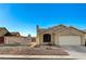 Single-story stucco home with a well-kept yard and a two-car garage, under a clear blue sky at 2177 Bridle Wreath Ln, Las Vegas, NV 89156