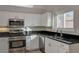 Bright kitchen with stainless steel appliances, granite countertops and white cabinetry at 2177 Bridle Wreath Ln, Las Vegas, NV 89156