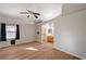 Well-lit primary bedroom featuring wood-look floors, ensuite bathroom, and window; offers comfort and functionality at 2177 Bridle Wreath Ln, Las Vegas, NV 89156