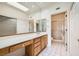 Bright bathroom featuring a large mirror, double sinks, white cabinets, and a walk-in shower with a glass door at 2520 Palmridge Dr, Las Vegas, NV 89134