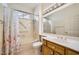 Bathroom featuring a single sink vanity, a mirror, and a tub with a shower and white curtain with red flowers at 2520 Palmridge Dr, Las Vegas, NV 89134