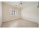 Neutral bedroom showcasing plantation shutters on the window and tile flooring at 2520 Palmridge Dr, Las Vegas, NV 89134