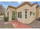 Tan home exterior showcasing a brick walkway and mature landscape at 2520 Palmridge Dr, Las Vegas, NV 89134