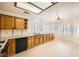 Well-lit kitchen with tiled floors, oak cabinetry, and white granite counters at 2520 Palmridge Dr, Las Vegas, NV 89134