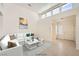 Bright living room featuring a white sofa, marble coffee table, and clerestory windows at 2520 Palmridge Dr, Las Vegas, NV 89134