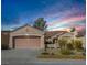 Single-story house with a two-car garage and desert landscaping at 2612 Harrisburg Ave, Henderson, NV 89052