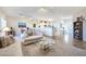 Open concept living area showcasing neutral tones, ample natural light, and a view to the kitchen at 2612 Harrisburg Ave, Henderson, NV 89052