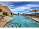 Inviting community pool with ample lounge chairs and umbrellas at 2612 Harrisburg Ave, Henderson, NV 89052