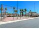 Community tennis court featuring fencing for privacy and palm tree lined scenery at 2631 Aracatuba Ave, Las Vegas, NV 89121