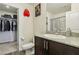 Bathroom with dark brown vanity, toilet, and walk-in closet at 2669 Champagne Gold Ave, North Las Vegas, NV 89086