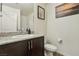 Bathroom with granite countertop and dark brown vanity at 2669 Champagne Gold Ave, North Las Vegas, NV 89086