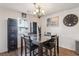 Bright dining room with glass-top table, chandelier, and hardwood floors at 2669 Champagne Gold Ave, North Las Vegas, NV 89086