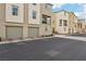 Row of tan townhomes with two-car garages at 2669 Champagne Gold Ave, North Las Vegas, NV 89086