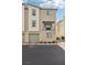 Tan townhome with balcony, two-car garage, and landscaping at 2669 Champagne Gold Ave, North Las Vegas, NV 89086