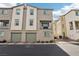 Tan two-story townhome with two-car garage and balcony at 2669 Champagne Gold Ave, North Las Vegas, NV 89086