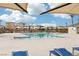 Community pool with lounge chairs and umbrellas at 2669 Champagne Gold Ave, North Las Vegas, NV 89086