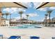 Resort-style pool with palm trees and lounge chairs at 2669 Champagne Gold Ave, North Las Vegas, NV 89086