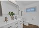 Updated bathroom with double vanity, modern fixtures, and frameless mirror at 2923 Palora Ave, Las Vegas, NV 89121