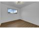 Simple bedroom with wood floors and large window at 2923 Palora Ave, Las Vegas, NV 89121