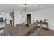 Dining area features a wood table, modern chandelier, and hardwood floors at 2923 Palora Ave, Las Vegas, NV 89121