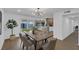 Spacious dining room with herringbone table, sliding glass doors, and kitchen view at 2923 Palora Ave, Las Vegas, NV 89121