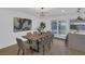 Bright dining room with large art piece, modern chandelier, and backyard access at 2923 Palora Ave, Las Vegas, NV 89121