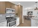 Updated kitchen featuring gas range, microwave, and light wood cabinets at 2923 Palora Ave, Las Vegas, NV 89121