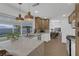 Open kitchen with white cabinets, large island, and modern pendant lighting at 2923 Palora Ave, Las Vegas, NV 89121