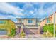 Two-story house with brown double-car garage, light beige exterior, and landscaping at 2934 Tremont Ave, Henderson, NV 89052