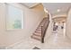 Staircase with dark brown railing leading to the second floor at 2934 Tremont Ave, Henderson, NV 89052