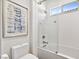 Clean bathroom with a bathtub, glass sliding door, and patterned tile at 304 Elder View Dr, Las Vegas, NV 89138