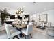 Modern dining room with a large table, contemporary lighting, and an open floor plan at 304 Elder View Dr, Las Vegas, NV 89138