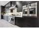 Modern kitchen with stainless steel appliances and dark cabinetry at 304 Elder View Dr, Las Vegas, NV 89138