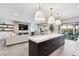 Modern kitchen with island, open living area, and fireplace at 304 Elder View Dr, Las Vegas, NV 89138