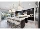 Modern kitchen with island, stainless steel appliances, and white quartz countertops at 304 Elder View Dr, Las Vegas, NV 89138