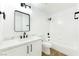 Modern bathroom with white cabinets and black accents at 3327 Erva St # 205, Las Vegas, NV 89117