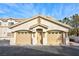 Two-car garage and entryway of a Spanish-style home at 3327 Erva St # 205, Las Vegas, NV 89117