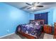 Cozy bedroom with wooden bed frame and ceiling fan at 4036 Floating Fern Ave, North Las Vegas, NV 89084