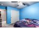 Blue bedroom with double closet and ceiling fan at 4036 Floating Fern Ave, North Las Vegas, NV 89084