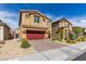 Two-story house with red garage door and nicely landscaped yard at 4036 Floating Fern Ave, North Las Vegas, NV 89084