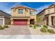 Two-story house with red garage door and landscaped yard at 4036 Floating Fern Ave, North Las Vegas, NV 89084