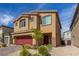 Two-story house with red garage door and well-maintained landscaping at 4036 Floating Fern Ave, North Las Vegas, NV 89084