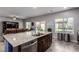 Modern kitchen island with granite countertops and stainless steel appliances at 4036 Floating Fern Ave, North Las Vegas, NV 89084