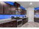 Modern kitchen with stainless steel appliances and granite countertops at 4036 Floating Fern Ave, North Las Vegas, NV 89084