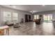 Open living room featuring tile floors and ample natural light from large windows at 4036 Floating Fern Ave, North Las Vegas, NV 89084