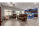 Spacious living room with tile floors, comfortable seating, and a view into the kitchen at 4036 Floating Fern Ave, North Las Vegas, NV 89084